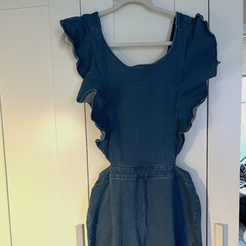 Retro 70s soft denim jumpsuit with open back, ruffle sleeve